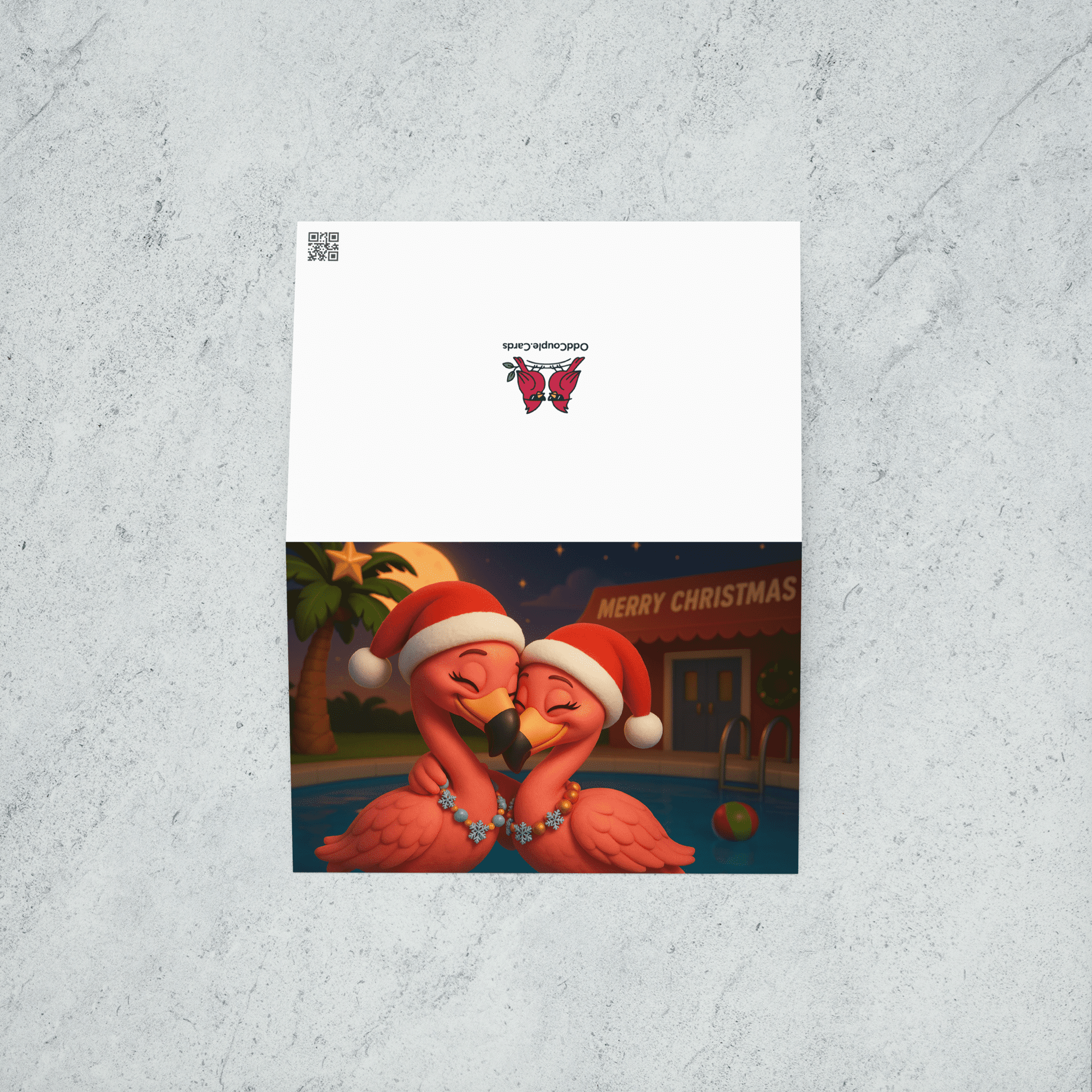 A Christmas card featuring two pink flamingos wearing red hats and snowflake necklaces in front of a pool and a palm tree decorated with a star. Back of card features the OddCouple.Cards logo.